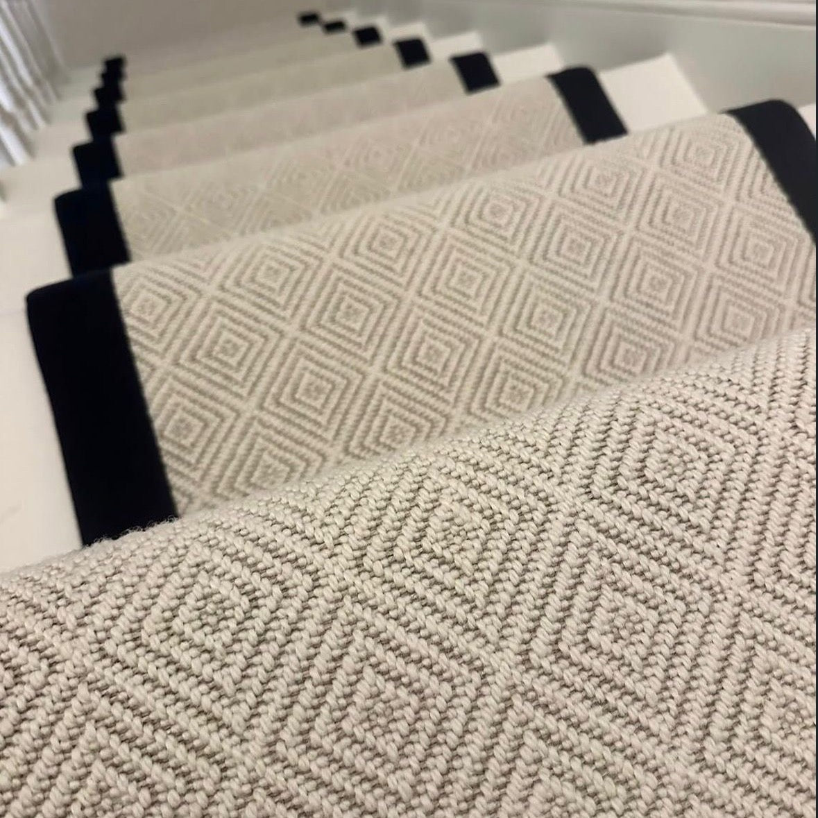 Diamond patterned wool stair runner with black binding